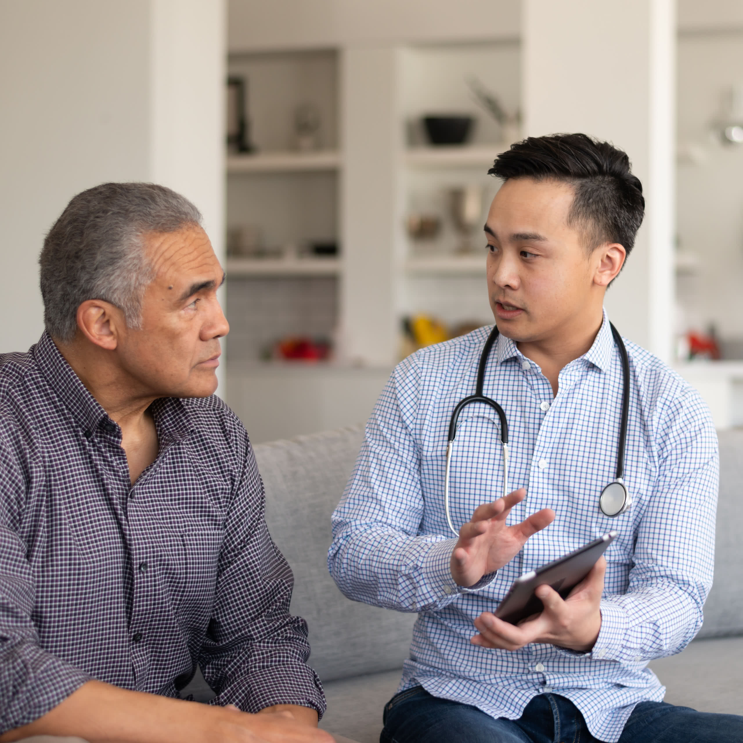 Healthcare provider consulting older patient