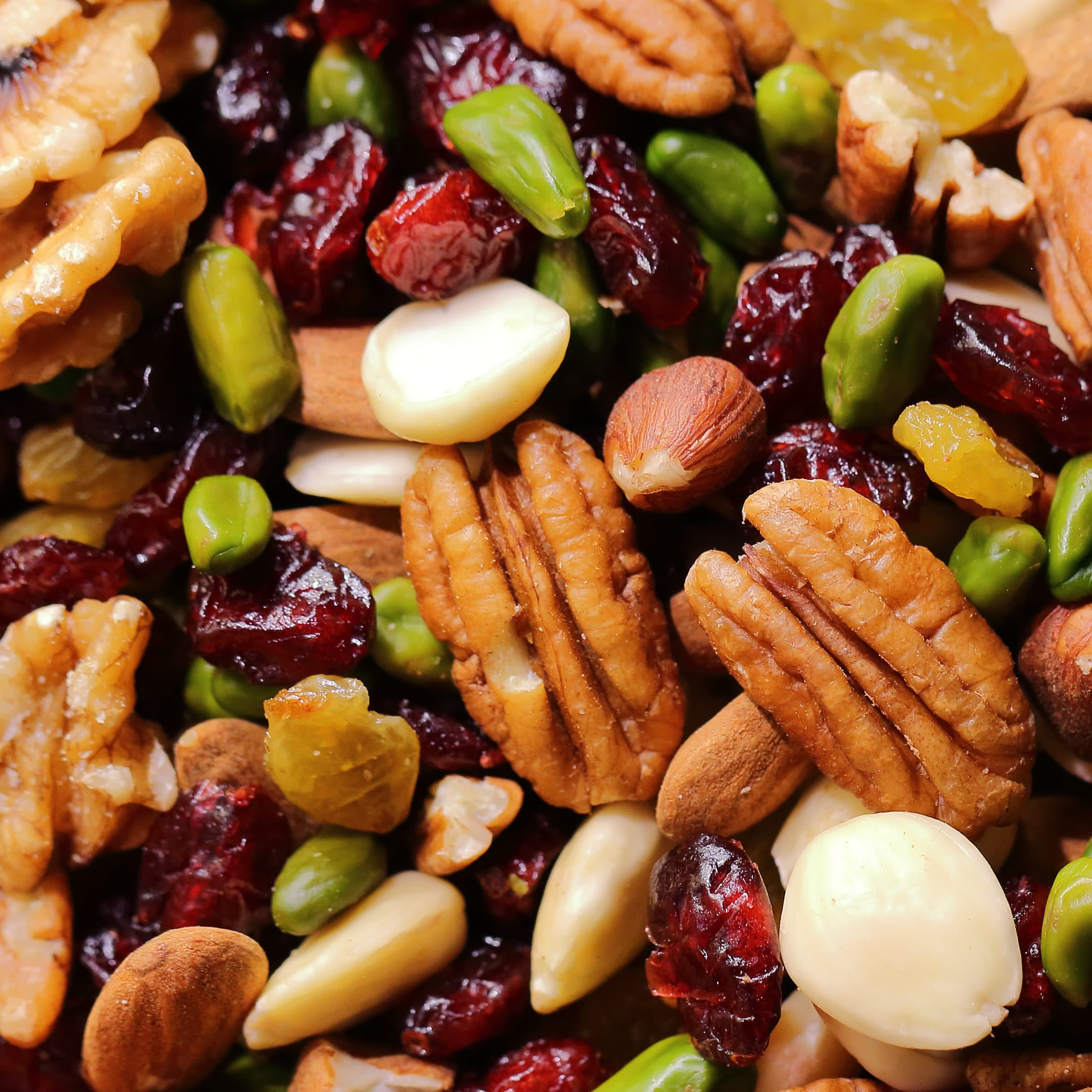 A healthy snack mix of nuts including pecans, almonds, pistachios, and macadamia nuts with dried cranberries